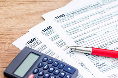 Income tax forms with a calulator