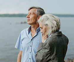 Retired couple looking out to see