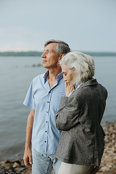 retired couple looking out toward sea