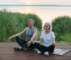 couple practicing mindful meditation doing yoga