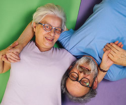 retired couple on colorful pillows