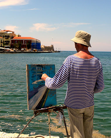 Artist painting at the coast