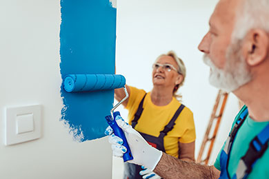Senior couple painting a wall