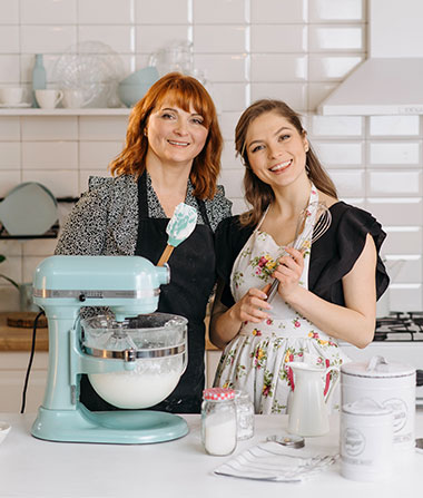 Mother and daughter in kitchen with stand mixer