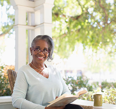 Woman enjoying reading on her porch