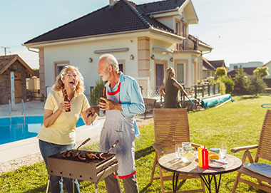 retired couple having a bbq in their backyard