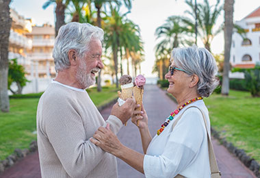 Retired couple enjoying ice cream outside of a retirment community