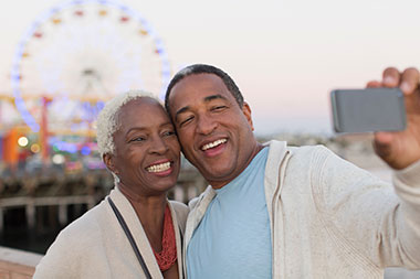 Retired couple enjoying a seaside amusement park 