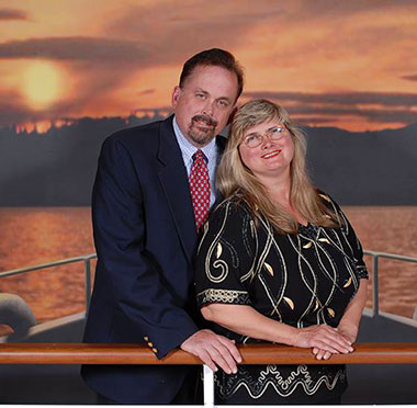 retired couple on cruise ship at sunset