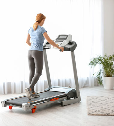 Woman on treadmill in home gym