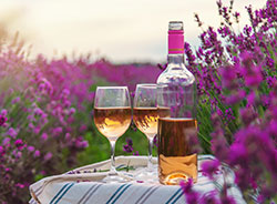 wine glasses and bottle in lavendar field